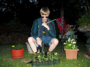 This undated image that appeared on Lastrhodesian.com, a website being investigated by the FBI in connection with Charleston, S.C., shooting suspect Dylann Roof, shows Roof posing for a photo while holding a Confederate flag. The website surfaced online Saturday, June 20, 2015, and also contained a hate-filled 2,500-word essay that talks about white supremacy and concludes by saying the author alone will need to take action. (Lastrhodesian.com via AP) MANDATORY CREDIT